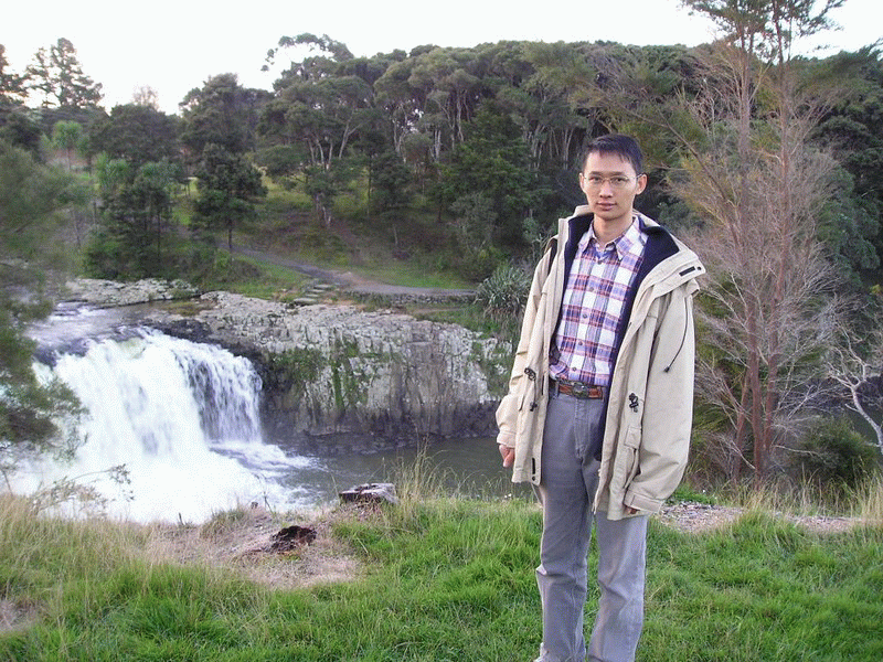 Ho Wing Long Winston in front of a waterfall.